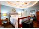 Main bedroom featuring tray ceilings, hardwood floors, and side tables at 1612 Cagle Ct, Lawrenceville, GA 30045