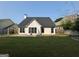 Home exterior featuring a spacious backyard with a patio, a lush lawn, and a cozy porch swing at 240 Turnbridge Cir, Peachtree City, GA 30269