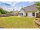 Spacious backyard with lush lawn, porch swing, and surrounding trees, ideal for outdoor activities at 240 Turnbridge Cir, Peachtree City, GA 30269