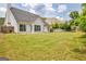 Expansive backyard with lush greenery and a cozy porch swing, creating an inviting outdoor retreat at 240 Turnbridge Cir, Peachtree City, GA 30269