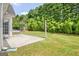Lush backyard with manicured lawn, complimented by a serene porch swing, providing a private escape at 240 Turnbridge Cir, Peachtree City, GA 30269