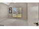 Spacious bedroom featuring neutral walls, carpet flooring, and a large window with neighborhood views at 240 Turnbridge Cir, Peachtree City, GA 30269