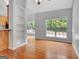 Sun-filled dining area with hardwood flooring, large windows, and view of the outside yard at 240 Turnbridge Cir, Peachtree City, GA 30269