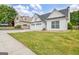 View of a charming home with a manicured lawn and a convenient three-car garage at 240 Turnbridge Cir, Peachtree City, GA 30269