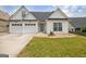 Attractive home featuring a three-car garage and a meticulously kept front lawn at 240 Turnbridge Cir, Peachtree City, GA 30269