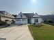 Bright single-story home featuring a two-car garage and a well-maintained lawn in a suburban setting at 240 Turnbridge Cir, Peachtree City, GA 30269