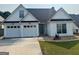 Charming single-story home with a two-car garage, landscaped front yard, and inviting gray front door at 240 Turnbridge Cir, Peachtree City, GA 30269