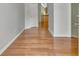 Bright hallway featuring gleaming hardwood floors leading to other rooms at 240 Turnbridge Cir, Peachtree City, GA 30269