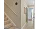 Bright hallway showcasing the staircase, complemented by neutral walls and tile flooring at 240 Turnbridge Cir, Peachtree City, GA 30269