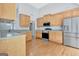 Bright kitchen featuring stainless steel appliances and light wood cabinetry at 240 Turnbridge Cir, Peachtree City, GA 30269