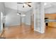 Open-concept living room featuring hardwood floors, bright walls, and an opening view into the kitchen area at 240 Turnbridge Cir, Peachtree City, GA 30269