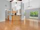Spacious living area with hardwood floors, tall ceilings, modern ceiling fans, and natural light from window at 240 Turnbridge Cir, Peachtree City, GA 30269