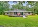 Expansive backyard features a brick patio and lush green lawn, perfect for outdoor relaxation at 100 Willow Wood Road, Social Circle, GA 30025