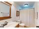 Neutral bathroom featuring a shower/tub with a curtain and a classic vanity with a framed mirror at 100 Willow Wood Road, Social Circle, GA 30025
