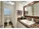 Bathroom featuring a toilet, shower with curtain and vanity with framed mirror at 100 Willow Wood Road, Social Circle, GA 30025
