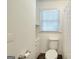 This bathroom features a toilet, shower with curtain and built-in storage at 100 Willow Wood Road, Social Circle, GA 30025