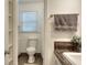 Compact bathroom featuring a toilet, a shower with curtain and brown tile at 100 Willow Wood Road, Social Circle, GA 30025