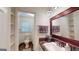 Bathroom featuring decorative mirror, vanity, open shelves, and toilet at 100 Willow Wood Road, Social Circle, GA 30025