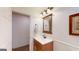 Well-lit bathroom featuring an enclosed vanity and light fixture above the mirror at 100 Willow Wood Road, Social Circle, GA 30025