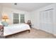 Bedroom featuring white walls, a large window, a closet, and neutral carpeting at 100 Willow Wood Road, Social Circle, GA 30025