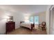 Cozy bedroom with single bed, side table with lamp, chair and chest of drawers on carpeted floor at 100 Willow Wood Road, Social Circle, GA 30025