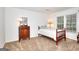 Bedroom with a dresser, large window, and neutral carpeting at 100 Willow Wood Road, Social Circle, GA 30025