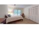 Carpeted bedroom featuring a single bed, lamp, accent chair, and closet with paneled doors at 100 Willow Wood Road, Social Circle, GA 30025