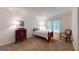 Cozy bedroom with a twin bed, a side chair, and a dresser, illuminated by a window and a lamp at 100 Willow Wood Road, Social Circle, GA 30025