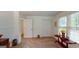 Carpeted room features a table with decorations, a door, and window with wooded view at 100 Willow Wood Road, Social Circle, GA 30025