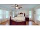 Spacious bedroom with hardwood floors, ceiling fan, and natural light at 100 Willow Wood Road, Social Circle, GA 30025