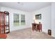 This is a well-lit bedroom with a curio cabinet and a wooden desk at 100 Willow Wood Road, Social Circle, GA 30025