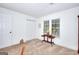 Bedroom featuring white walls, a large window, and neutral carpeting at 100 Willow Wood Road, Social Circle, GA 30025