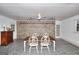 Dining room with unique stone floors and exposed brick walls at 100 Willow Wood Road, Social Circle, GA 30025