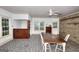 Open dining room with stone floors, exposed brick, and built-in bar area at 100 Willow Wood Road, Social Circle, GA 30025