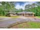Charming brick ranch home featuring a circular driveway and beautifully landscaped front yard at 100 Willow Wood Road, Social Circle, GA 30025