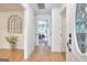 Bright hallway features hardwood floors, white wall paneling and access to multiple rooms at 100 Willow Wood Road, Social Circle, GA 30025