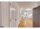 Hallway with hardwood floors leads to kitchen and front door at 100 Willow Wood Road, Social Circle, GA 30025