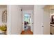 Hallway with hard wood flooring and neutral white walls at 100 Willow Wood Road, Social Circle, GA 30025