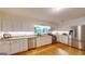 Well-lit kitchen showcasing stainless steel appliances, granite countertops, and white cabinets at 100 Willow Wood Road, Social Circle, GA 30025