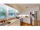 Bright kitchen with white cabinets, granite countertops, and stainless steel appliances at 100 Willow Wood Road, Social Circle, GA 30025