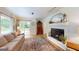 Inviting living room features a cozy fireplace, comfortable seating, and access to the outdoors at 100 Willow Wood Road, Social Circle, GA 30025
