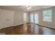 Bright bedroom with hardwood floors, double doors to the backyard, and a closet at 489 Radar Dr, Hapeville, GA 30354