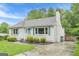 One-story home showcasing neat landscaping, a paved driveway, and bright blue shutters at 489 Radar Dr, Hapeville, GA 30354