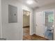 Hallway providing access to a bedroom with ceiling fan and a bathroom at 489 Radar Dr, Hapeville, GA 30354