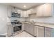 Updated kitchen showcasing stainless steel appliances, granite countertops, and a tile backsplash at 489 Radar Dr, Hapeville, GA 30354