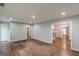 Spacious living room featuring beautiful hardwood floors, neutral wall color, and multiple doorways at 489 Radar Dr, Hapeville, GA 30354