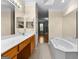 Bathroom with double vanity, soaking tub, and tile floors at 130 Augusta Dr, Peachtree City, GA 30269
