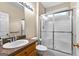 Bathroom featuring a walk-in shower with glass doors and granite countertop at 130 Augusta Dr, Peachtree City, GA 30269