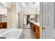 Bathroom featuring soaking tub, double vanity, tile floors and a mirrored closet at 130 Augusta Dr, Peachtree City, GA 30269
