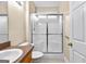 Bathroom showcasing a walk-in shower with a glass door and tiled floor at 130 Augusta Dr, Peachtree City, GA 30269